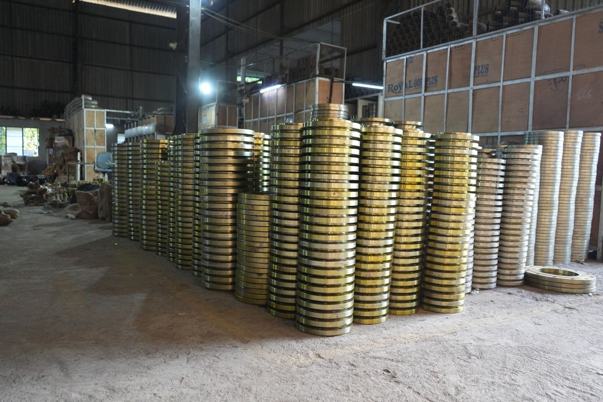 Large stacks of carbon steel flanges in a warehouse