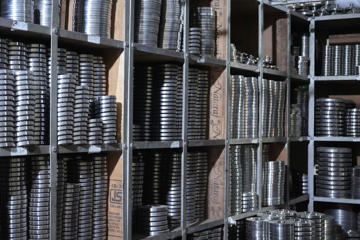 Racks of finished stainless steel flanges sorted by size in the RIC stores