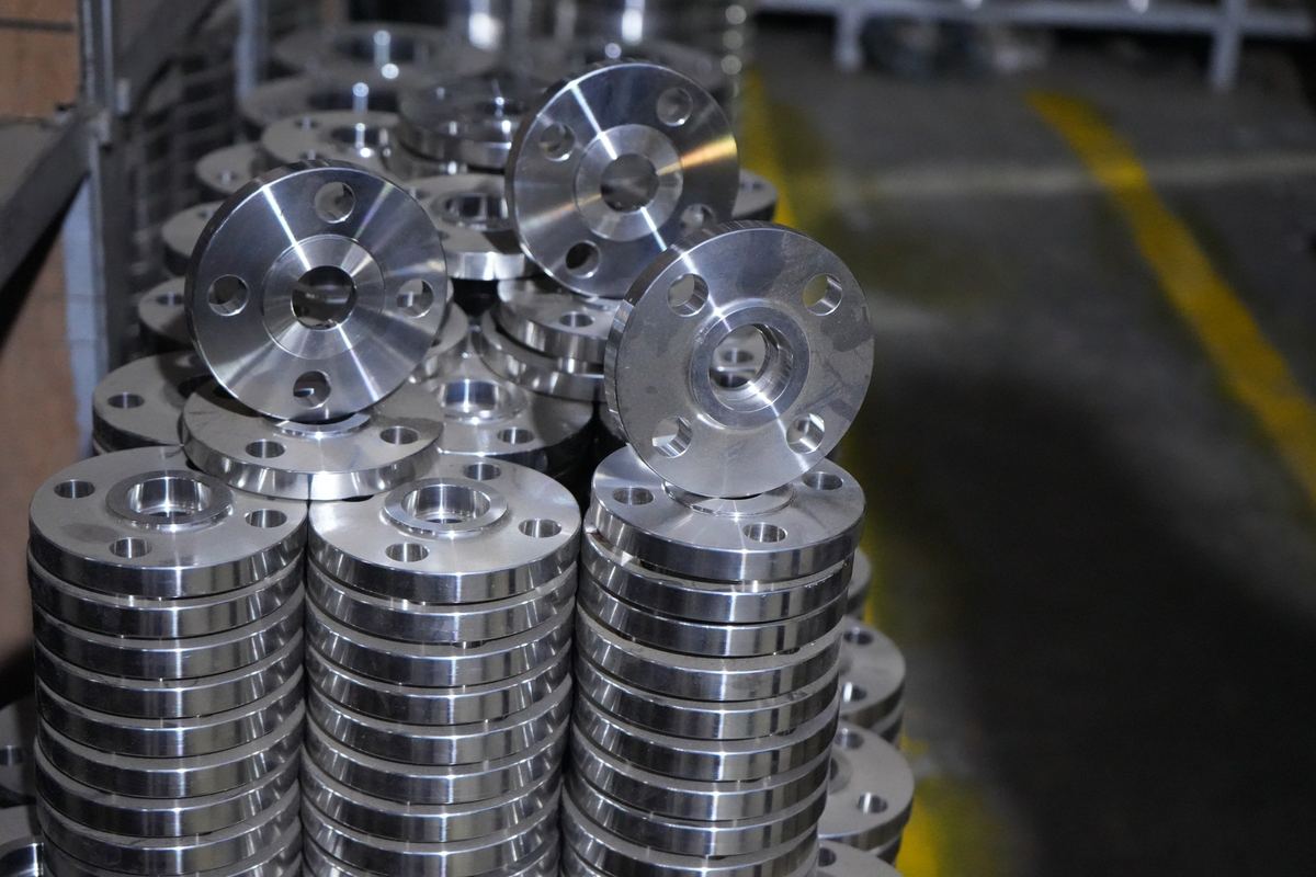 Stacks of machined stainless steel slip-on flanges in the RIC stores at Umbergaon